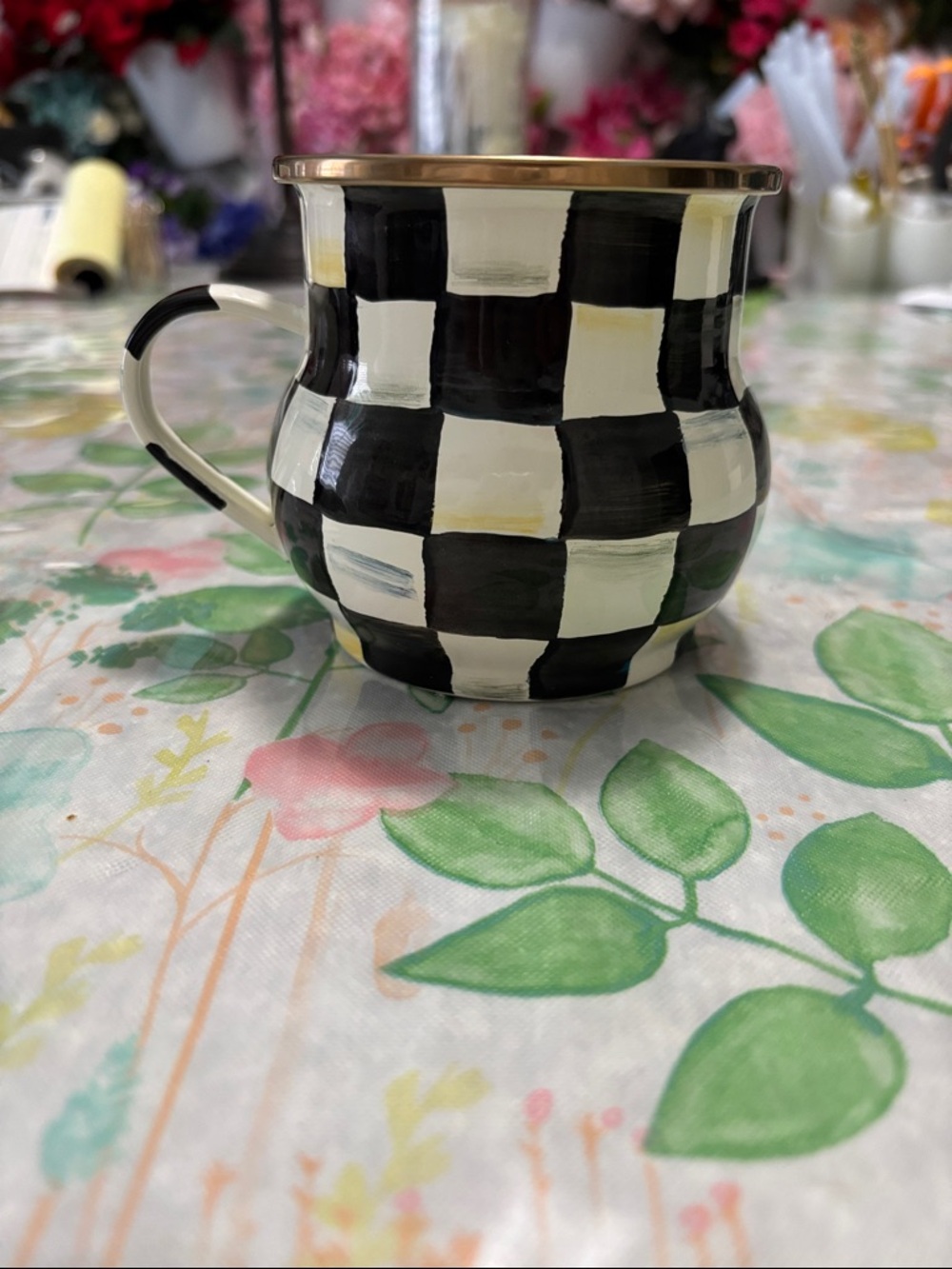 MacKenzie-Childs ceramic mug with signature black and white check pattern.